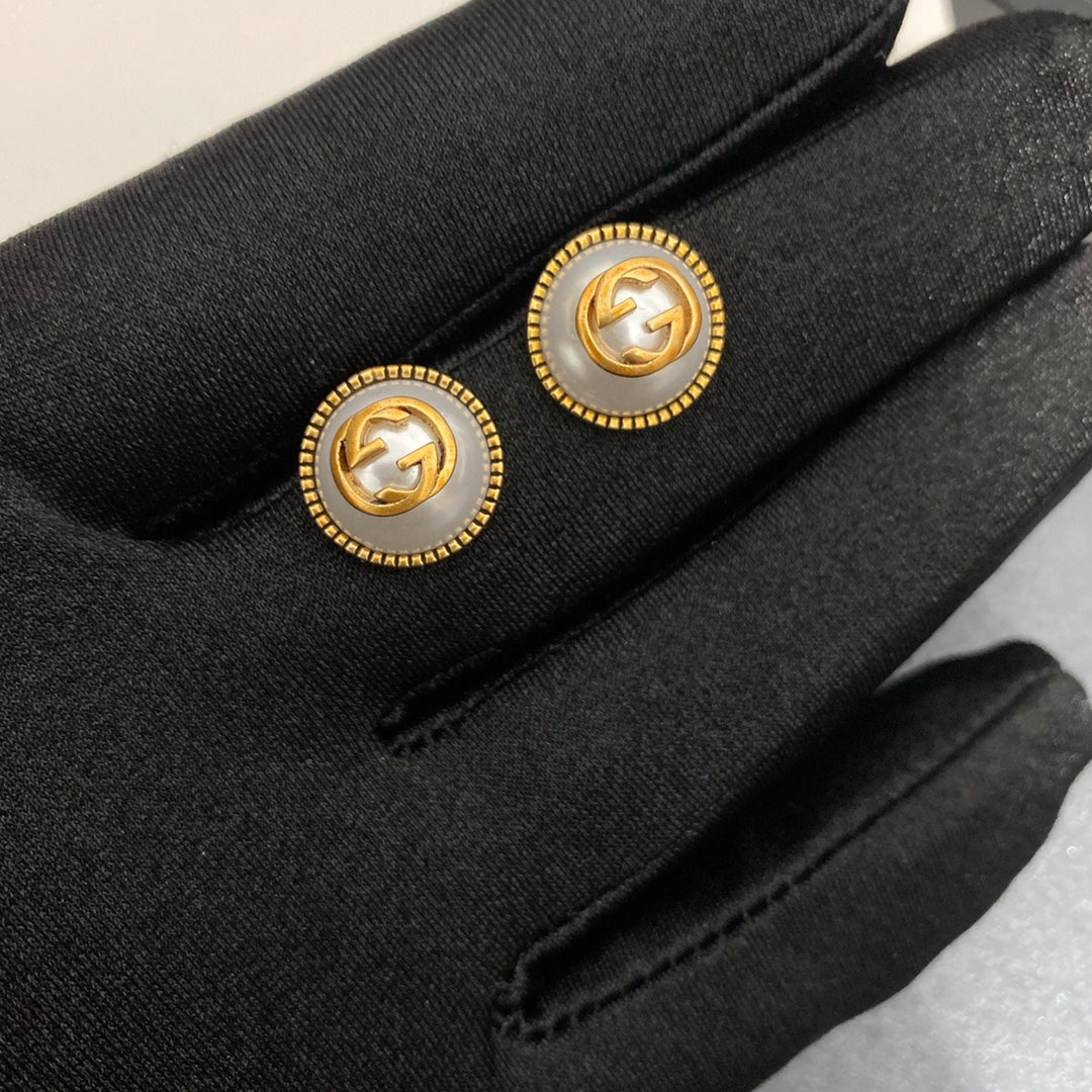 Pearl and brass earrings